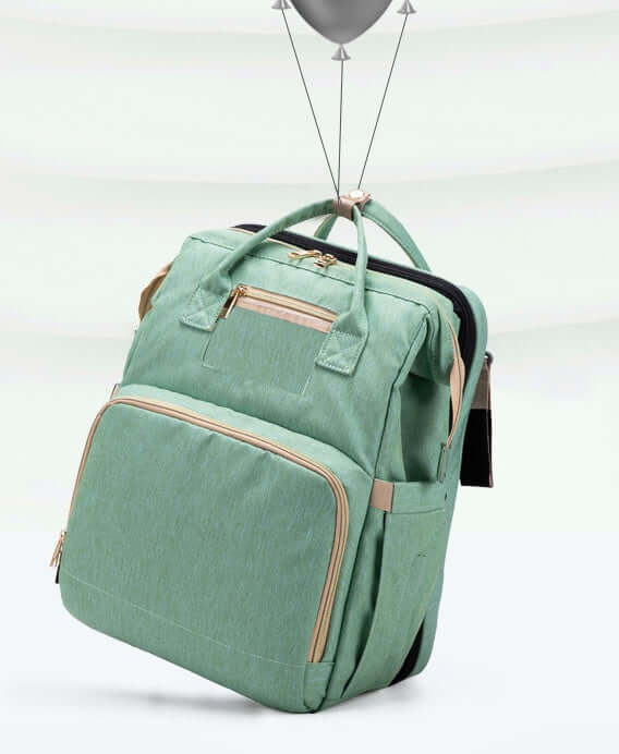 Sac à dos pliable multifonction vert avec poches pratiques et chargement USB, idéal pour les mamans