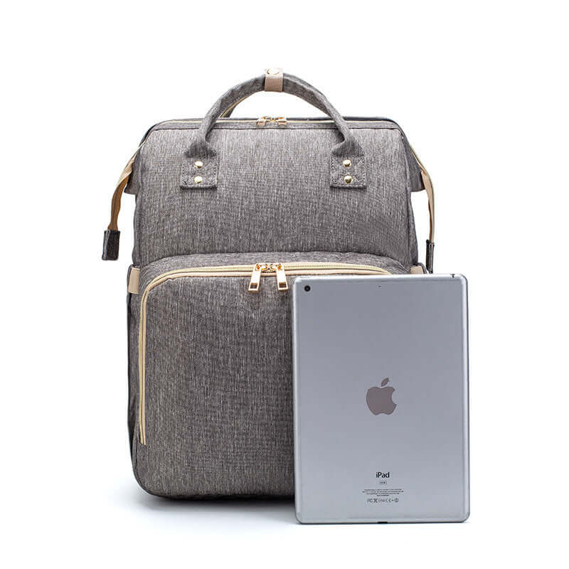 Sac à dos pliable multifonction avec chargeur USB, idéal pour les mamans, avec tablette en avant.